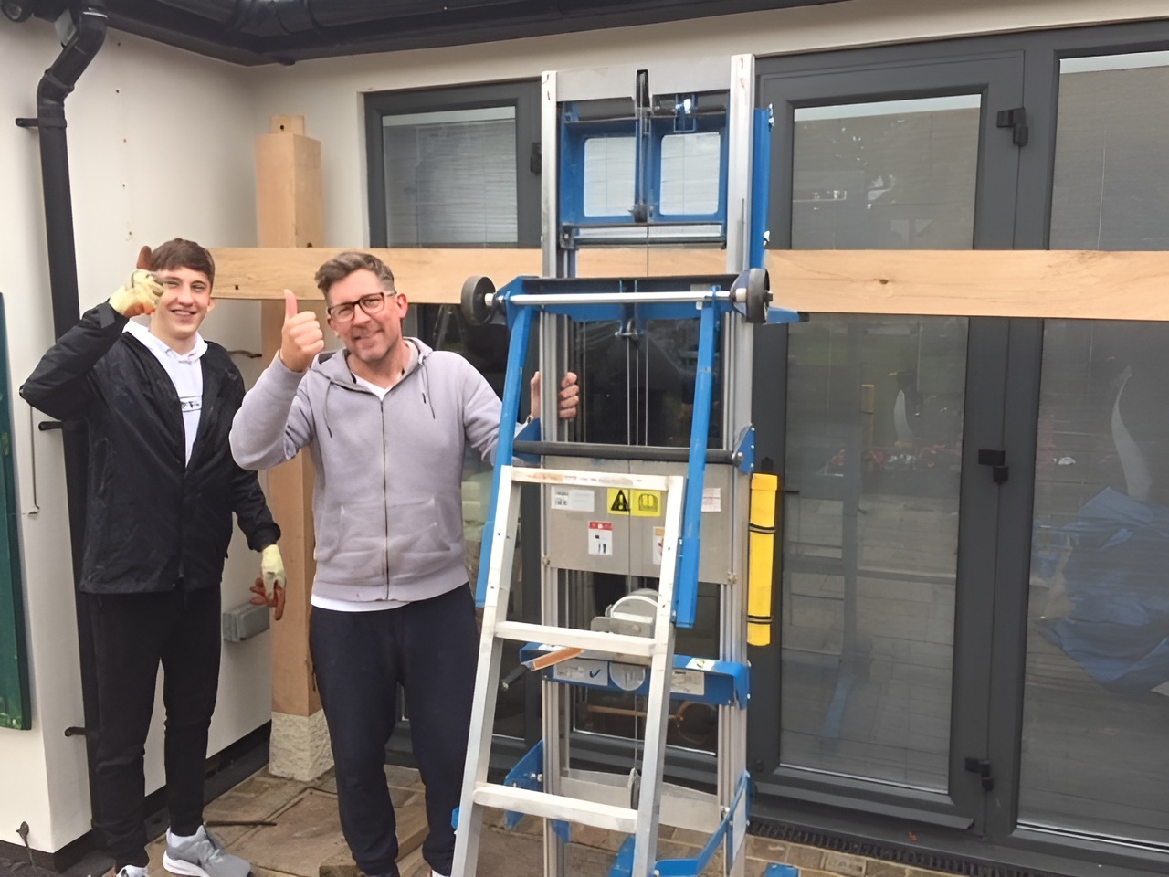 homeowner and son DIY building oak pergola